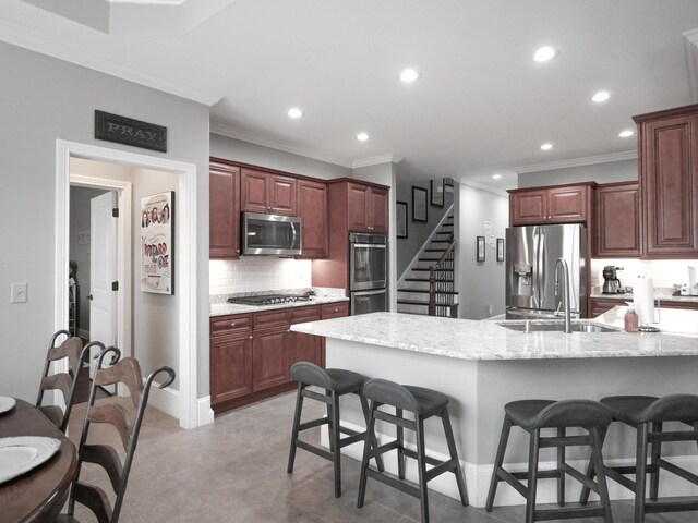 kitchen featuring reddish brown cabinets, stainless steel appliances, recessed lighting, backsplash, and light stone countertops