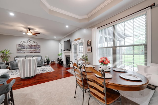 dining area featuring a fireplace with flush hearth, ceiling fan, crown molding, and recessed lighting