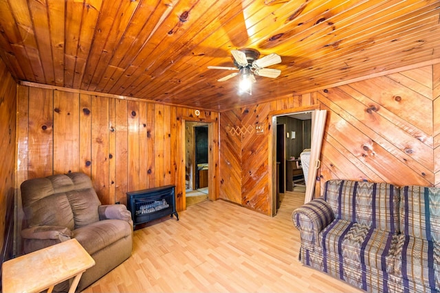 living area featuring wooden walls, wood ceiling, and light wood-style floors