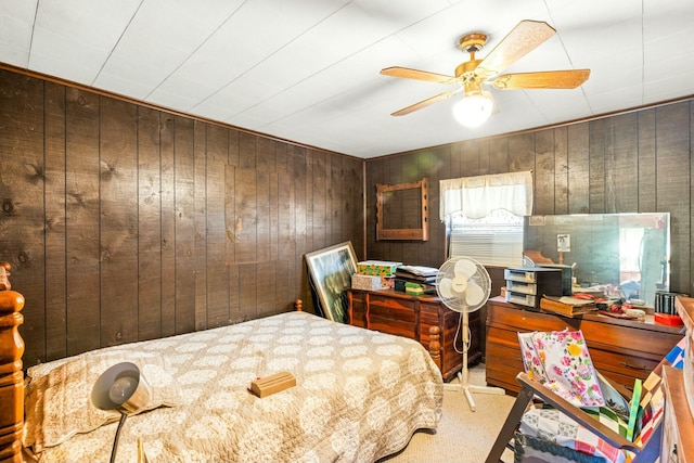 bedroom with wooden walls and a ceiling fan