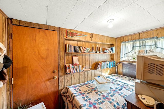 bedroom with wood walls