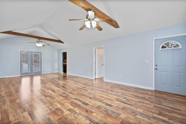 unfurnished living room with baseboards, a ceiling fan, wood finished floors, and vaulted ceiling with beams