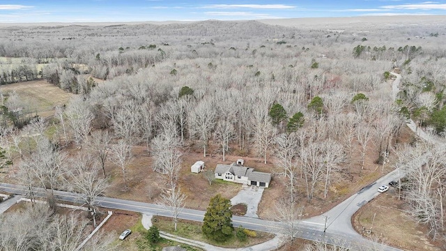 birds eye view of property with a wooded view