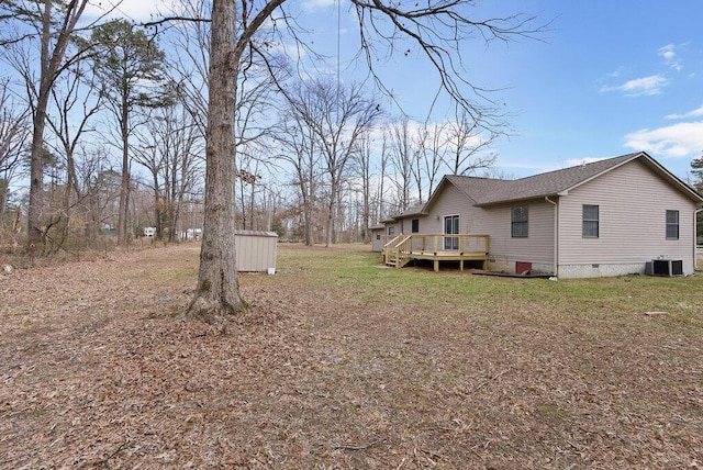 view of yard with cooling unit and a wooden deck