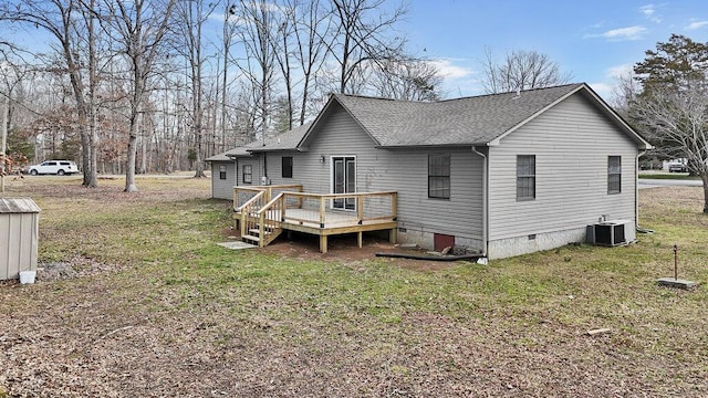 back of property featuring crawl space, a yard, a deck, and roof with shingles