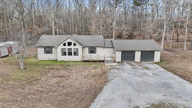 view of front of house featuring driveway, a wooden deck, an attached garage, a shingled roof, and crawl space