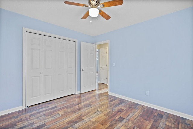 unfurnished bedroom with wood finished floors, baseboards, a closet, and ceiling fan