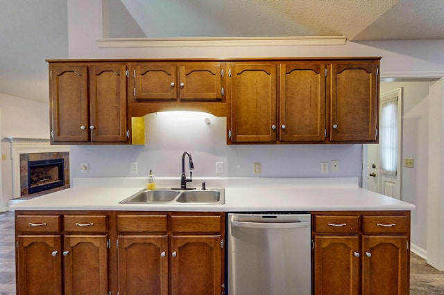 519 Cedar Glen Cir, Chattanooga, TN 37412 - kitchen with stainless steel dishwasher, a sink, light countertops, and brown cabinetry
