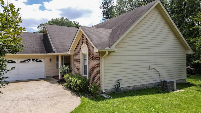 519 Cedar Glen Cir, Chattanooga, TN 37412 - view of home's exterior with central AC unit, a garage, concrete driveway, brick siding, and a lawn