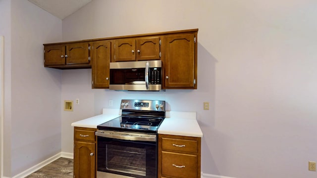 519 Cedar Glen Cir, Chattanooga, TN 37412 - kitchen featuring appliances with stainless steel finishes, light countertops, baseboards, lofted ceiling, and brown cabinets
