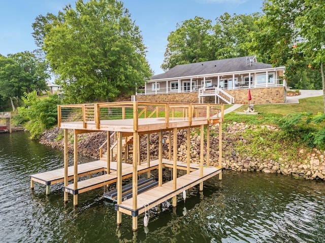 dock area featuring stairs and a deck with water view