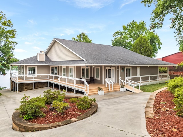 farmhouse-style home featuring covered porch and french doors