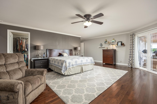 bedroom with access to exterior, dark hardwood / wood-style flooring, ceiling fan, and a walk in closet