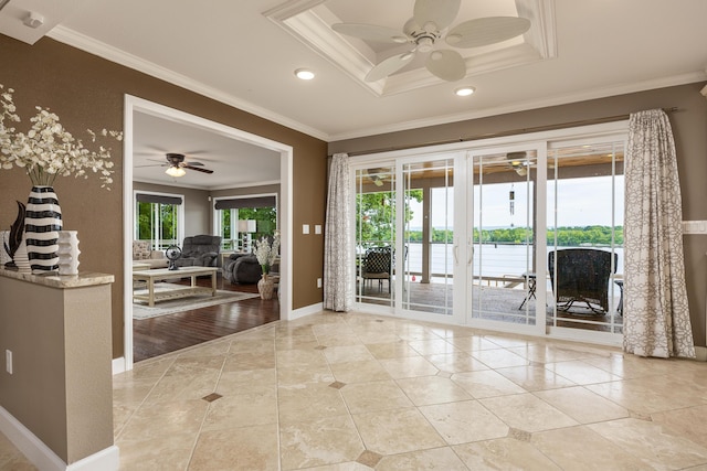 interior space featuring ceiling fan, light wood-type flooring, and crown molding