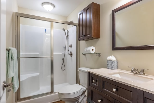 bathroom with vanity, toilet, and an enclosed shower