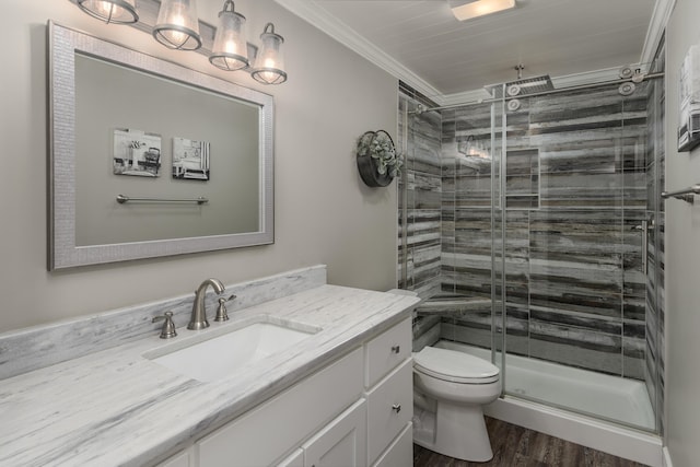 114 Monroe Dr, Ringgold, GA 30736 - bathroom with a shower stall, toilet, vanity, wood finished floors, and ornamental molding