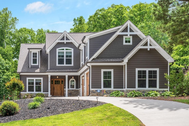 114 Monroe Dr, Ringgold, GA 30736 - craftsman inspired home featuring stone siding, a porch, driveway, and a shingled roof