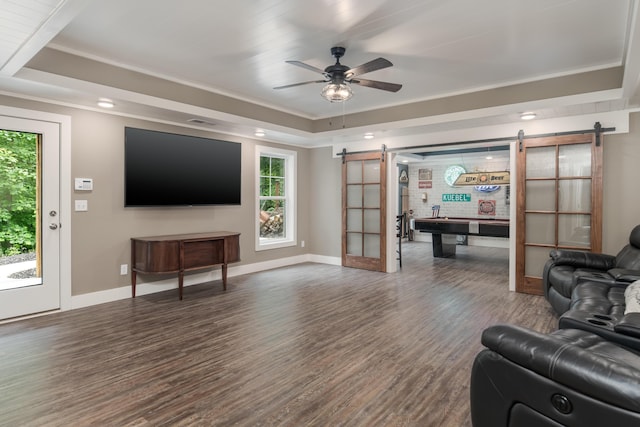 114 Monroe Dr, Ringgold, GA 30736 - living room featuring a barn door, a tray ceiling, healthy amount of natural light, wood finished floors, and ornamental molding