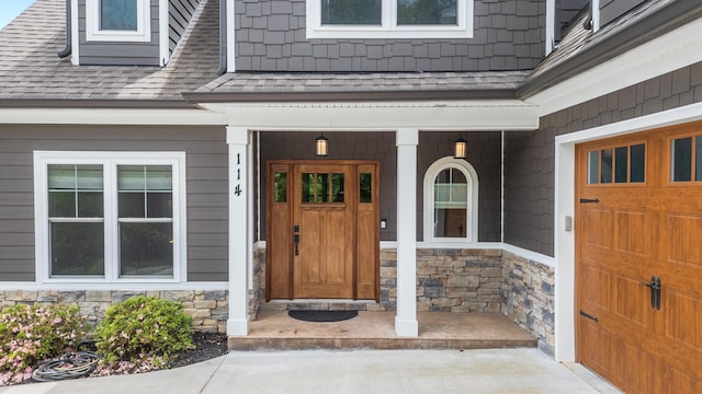 114 Monroe Dr, Ringgold, GA 30736 - doorway to property featuring stone siding, a shingled roof, and covered porch
