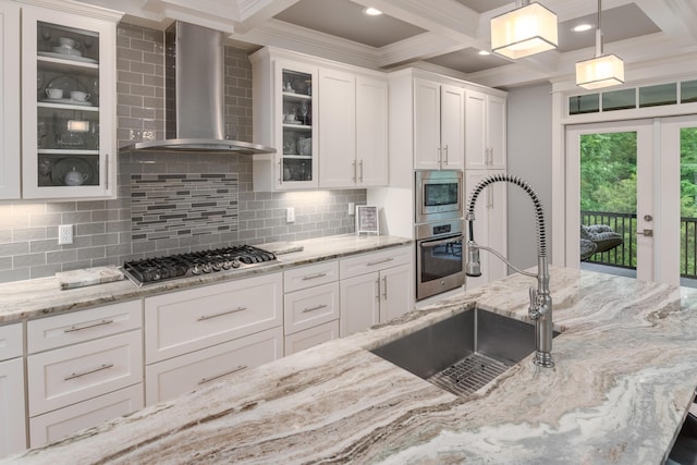114 Monroe Dr, Ringgold, GA 30736 - kitchen featuring wall chimney exhaust hood, appliances with stainless steel finishes, white cabinetry, a sink, and ornamental molding