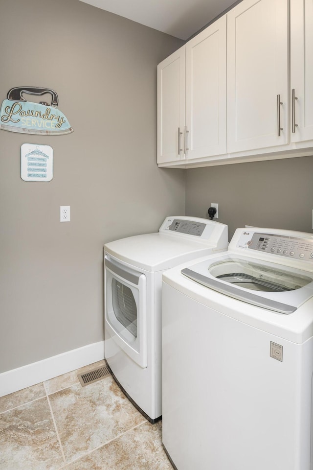 114 Monroe Dr, Ringgold, GA 30736 - laundry area featuring cabinet space, separate washer and dryer, and baseboards