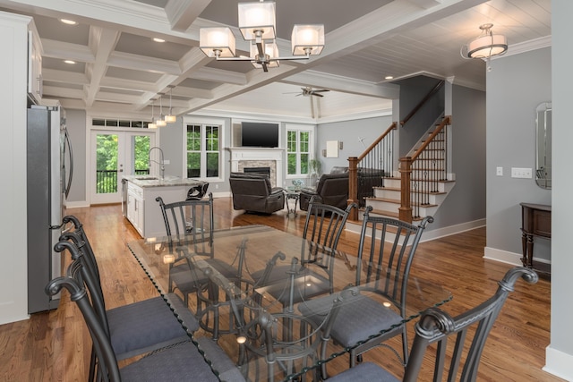 114 Monroe Dr, Ringgold, GA 30736 - dining room featuring ceiling fan, a fireplace, ornamental molding, beamed ceiling, and light wood finished floors