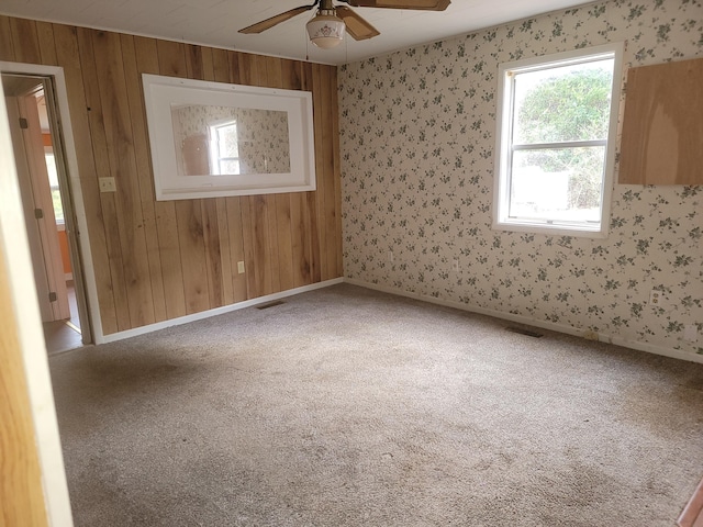 138 Singo Dr, Turtletown, TN 37391 - spare room with plenty of natural light, ceiling fan, carpet floors, wallpapered walls, and wood walls