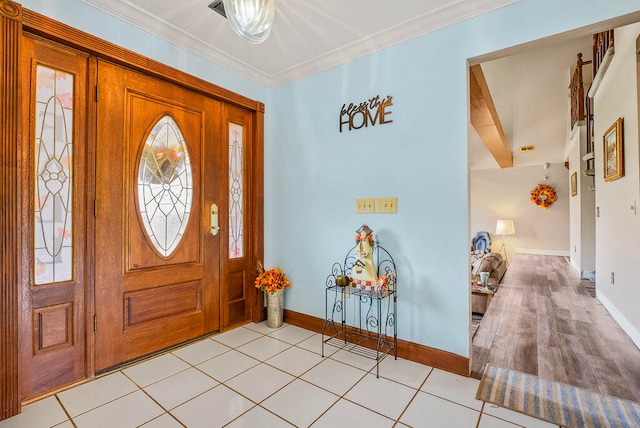 entrance foyer featuring beamed ceiling, light tile patterned floors, and ornamental molding