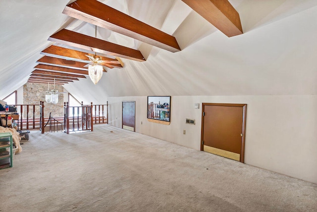 unfurnished living room featuring carpet flooring, ceiling fan, and vaulted ceiling with beams