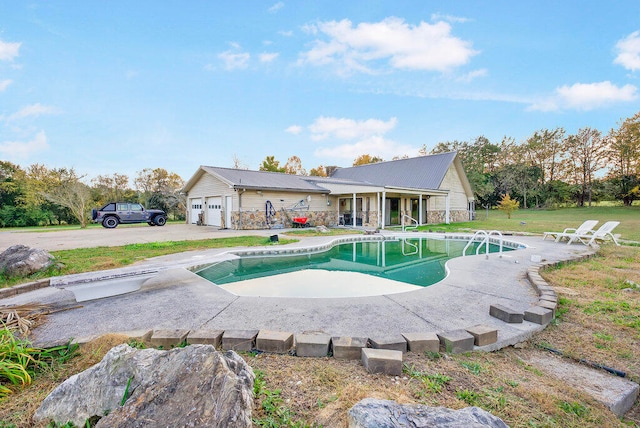 view of pool with a diving board and a lawn