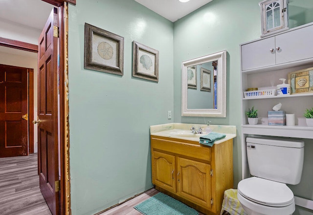 bathroom with vanity, hardwood / wood-style flooring, and toilet