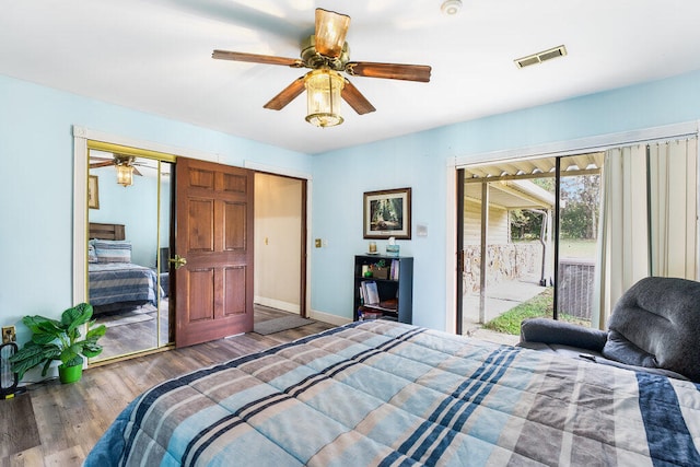 bedroom featuring a closet, access to outside, ceiling fan, and dark wood-type flooring