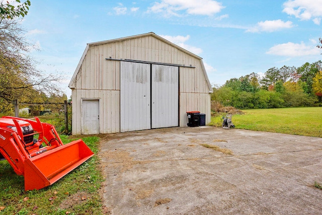 view of outbuilding featuring a lawn