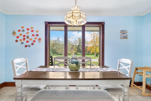 dining space with light tile patterned flooring, ornamental molding, and an inviting chandelier