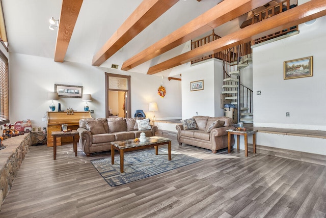 living room featuring beamed ceiling and hardwood / wood-style flooring