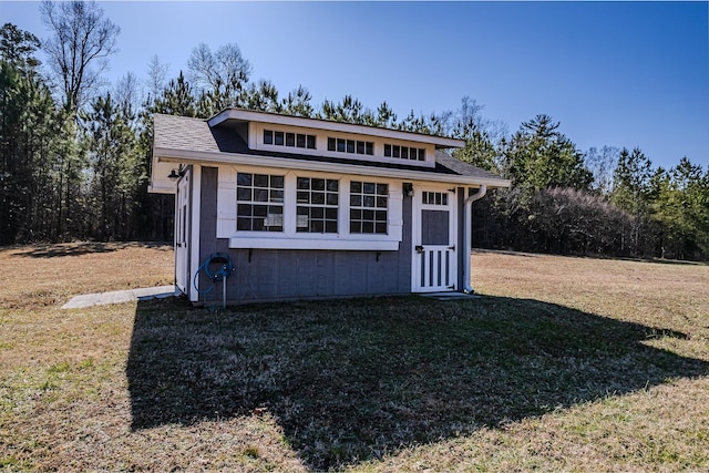 view of outdoor structure featuring a lawn