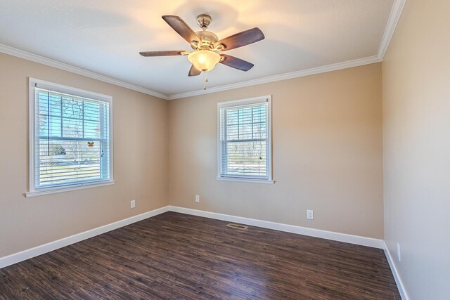 empty room featuring crown molding, dark wood-type flooring, and ceiling fan