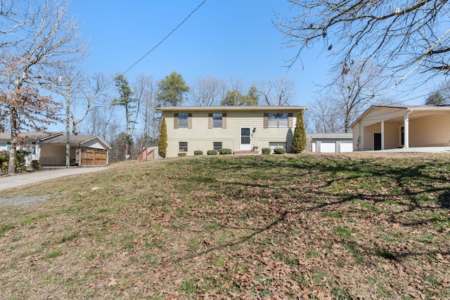 raised ranch with a garage and a front lawn