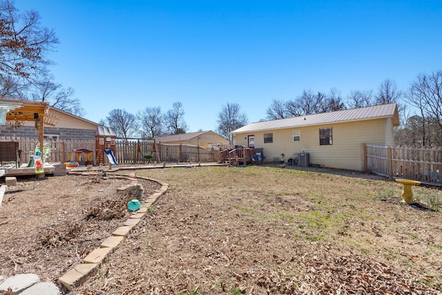 view of yard with a fenced backyard and a playground