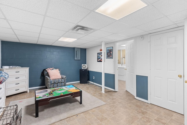 rec room featuring concrete block wall, electric panel, visible vents, and a paneled ceiling