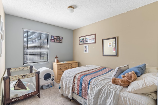 carpeted bedroom featuring a textured ceiling