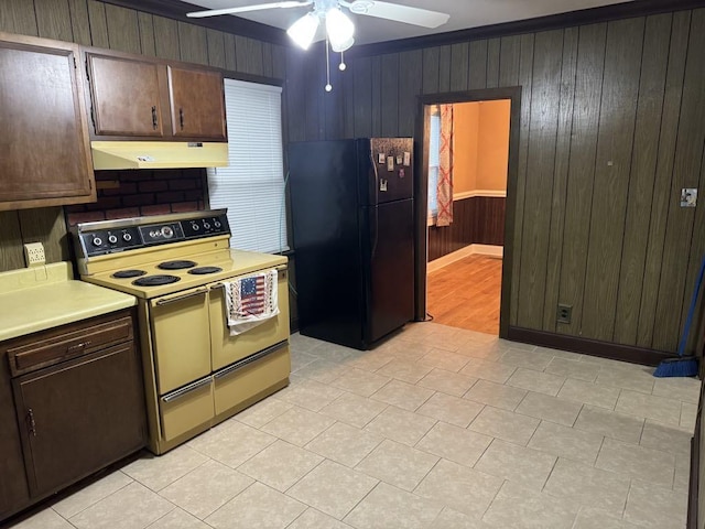 kitchen with light countertops, range with electric cooktop, freestanding refrigerator, a ceiling fan, and under cabinet range hood