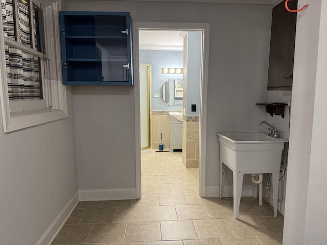 interior space with tile patterned floors and baseboards