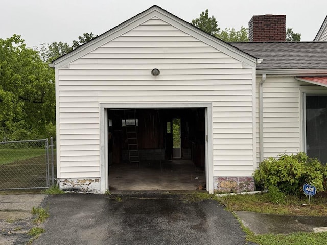 garage featuring aphalt driveway