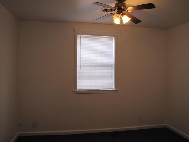 empty room with plenty of natural light, baseboards, and a ceiling fan