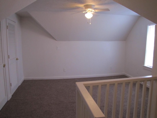 additional living space with carpet floors, vaulted ceiling, and plenty of natural light