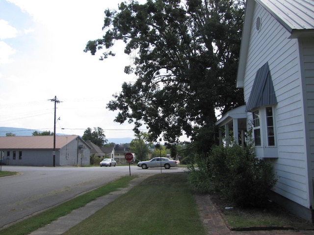 view of road featuring traffic signs and sidewalks