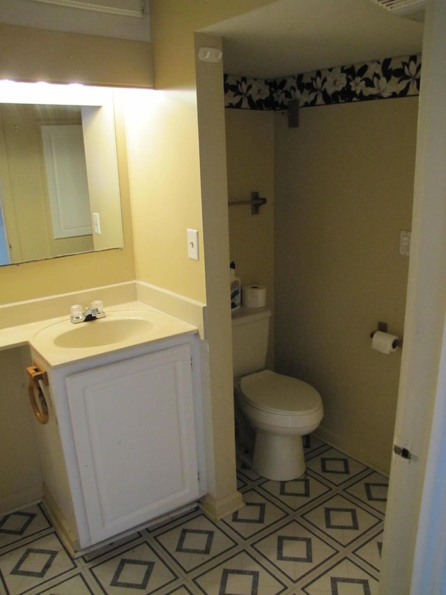 bathroom featuring toilet and vanity