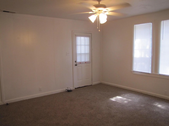 spare room with a ceiling fan, baseboards, visible vents, and carpet flooring