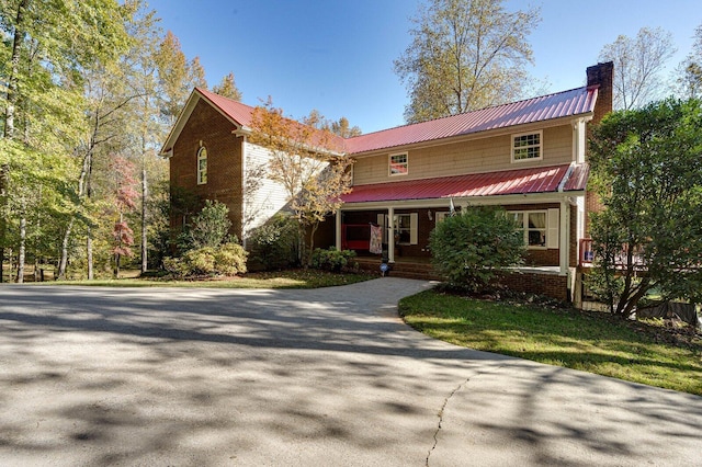 view of property featuring covered porch